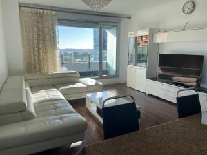 a living room with a couch and a fireplace at Fira de Barcelona City View Apartment with Garage Parking in Hospitalet de Llobregat