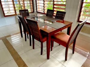a dining room with a wooden table and chairs at Bua Bed & Breakfast in Nadi