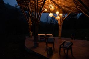 a pavilion with chairs and a table and lights at Espacio Pilam y cascada privada! in Xico