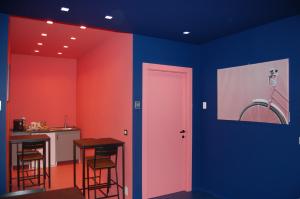 a room with blue and red walls and a door at Dimora 81 in Syracuse