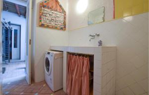 a bathroom with a washing machine and a sink at Art Gallery Flat in Amantea