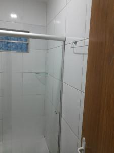 a bathroom with a shower with a glass door at Dunas Residence - Casa 06 in Santo Amaro +26 photos