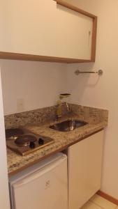 a kitchen with a sink and a counter top at Flat Constelações in Campos dos Goytacazes