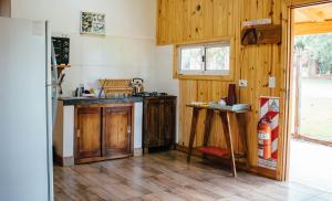 eine Küche mit Holzschränken und einer Arbeitsplatte in der Unterkunft CABAÑAS LA AMISTAD in Puerto Iguazú