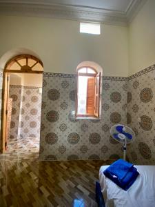 een slaapkamer met een bed, een raam en een tafel bij Dar Haniya in Rabat