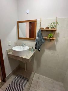 uma casa de banho com um lavatório e um espelho em Casa Duplex em Cabo Frio - pertinho de tudo! em Cabo Frio