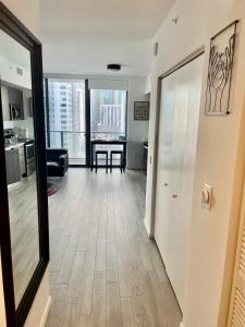 a living room with a hallway with a table at Beautiful downtown ocean view. in Miami
