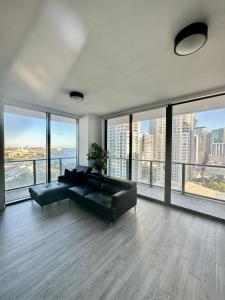 a living room with a black couch and large windows at Beautiful downtown ocean view. in Miami
