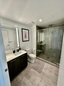 a bathroom with a toilet and a sink and a shower at Beautiful downtown ocean view. in Miami