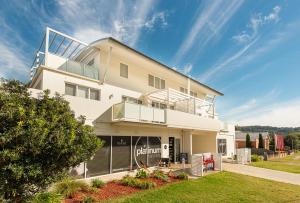a large white building with a lot of windows at Warners Bay Apartments in Warners Bay