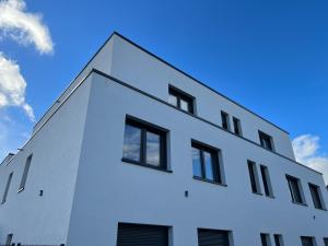 a white building with black windows on the side of it at BonApart in Bedburg