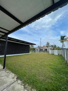 a large yard in front of a house at Nur Villa Sg Soi Musslimm Only in Kuantan