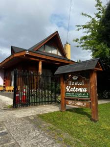 a sign in front of a house with a fence at Hostal Katemu in Villarrica +15 photos