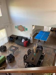 a living room with a ping pong table and a ping pong table at Casa con vista a las sierras de Cordoba in Malagueño