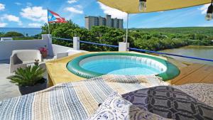 a swimming pool on the deck of a house at Palmeras Beach Apartments - Playa Santa in Guanica