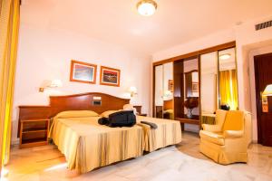 Hotel Abades Loja tesisinde bir odada yatak veya yataklar
