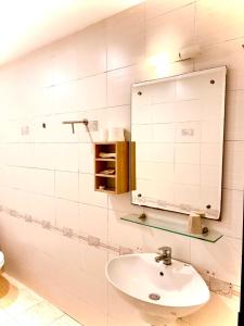 a bathroom with a sink and a mirror at Ibiz City Hotel in Hanoi