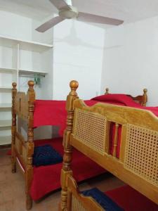 two beds in a room with a ceiling fan at Quinta campestre Amor Secreto. Alojamiento entero en renta in Temixco