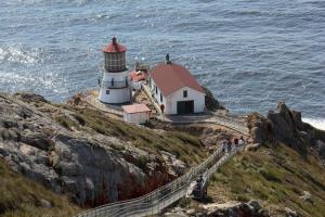 a lighthouse on a cliff next to the ocean at Not A Bank in Tomales