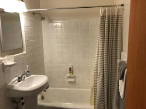 a bathroom with a sink and a toilet and a tub at Walk2Metro's,DCGem,Private,Wifi, FreeParking in Arlington +47 photos