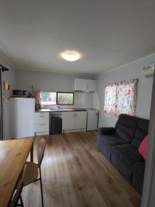 a living room with a couch and a table at Zeehan Bush Camp in Zeehan