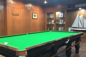 a pool table in a room with a boat at Greenleas, Cottage, Swimming Pool and Log Fire in Mae Chan