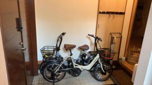 two bikes parked next to each other in a hallway at Free Parking VAMOS A VER御宿 #RK1 in Iwada