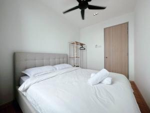 - une chambre avec un lit blanc et un ventilateur de plafond dans l'établissement DASA Homes (Sea View, Drawbridge & KTCC Mall), à Kuala Terengganu