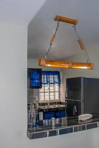 uma cozinha com armários azuis e um frigorífico de aço inoxidável em D' Yoko Village's em Pedernales