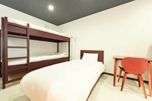 a bedroom with a bed and a desk and a bunk bed at HEIGHTS N7 in Kita-rokujō