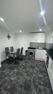 a kitchen with a table and chairs and a stove at 2 bed room luxury apartment in old Kent road London in London