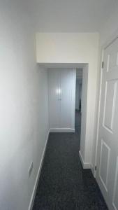 an empty room with white walls and a door at 2 bed room luxury apartment in old Kent road London in London