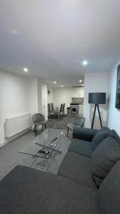 a living room with a blue couch and a table at 2 bed room luxury apartment in old Kent road London in London