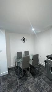 a dining room with a table and two chairs at 2 bed room luxury apartment in old Kent road London in London