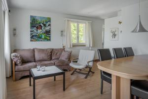 a living room with a couch and a table at Kirschstein OG in Fiesch