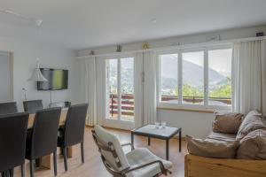 a living room with a table and chairs and a dining room at Kirschstein OG in Fiesch