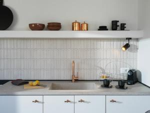 a kitchen with a sink and a counter top at Icos village house in Hersonissos