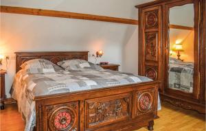 a bedroom with a wooden bed and a large mirror at Holiday Home Rue Jarl Priel in Plouguiel