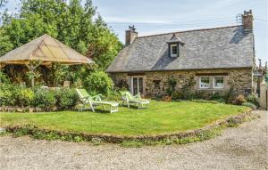 a stone house with chairs and a gazebo at Nice Home In Plouguiel With 2 Bedrooms in Plouguiel