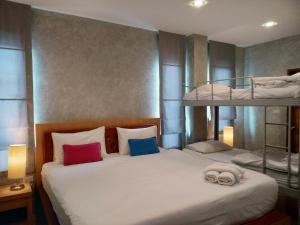 a bedroom with two bunk beds with towels on the bed at De Loft Hotel in Ao Nang Beach