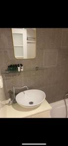 a bathroom with a white sink and a mirror at Tish Hotel in Jerusalem