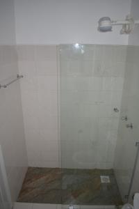 a shower with a glass door in a bathroom at One bedroom apartment in Nairobi