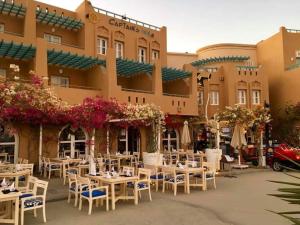 a restaurant with tables and chairs in front of a building at El Gouna Lagoon Paradise Penthouse in Hurghada
