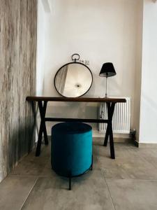 a dressing table with a mirror and a blue stool at Escala Luxury Loft 2 in the center &Free Parking in Volos