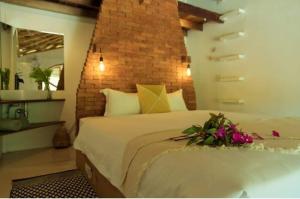 a bedroom with a large bed with flowers on it at Aloe Ecological Boutique Villa 2 in Ao Nam Mao