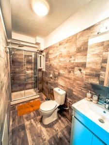 a bathroom with a toilet and a sink and a shower at Escala Luxury Loft 2 in the center &Free Parking in Volos