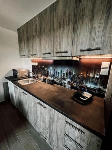 a kitchen with a counter top with a bar at Escala Luxury Loft 2 in the center &Free Parking in Volos