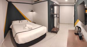 Postel nebo postele na pokoji v ubytování Smile Hotel Klang Bukit Tinggi
