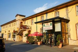 a man walking in front of a building at Hotel San Marco in Lannach