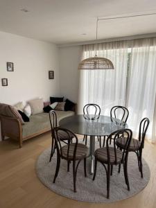 a dining table and chairs in a living room at Zeehuis in Koksijde